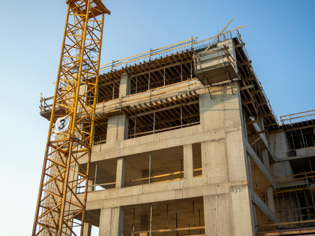 Yellow construction crane with building